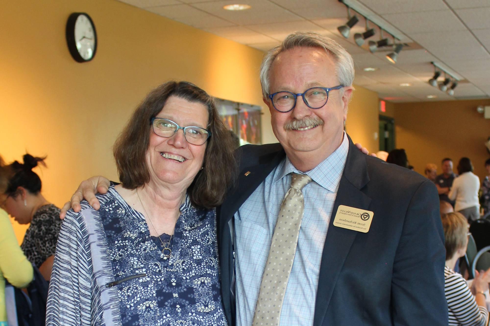 Photo of two GVSU retirees, Scott Richardson and Bonnie Maka, smiling with their arms around each other